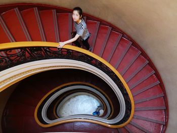 Portrait of woman walking on spiral staircase