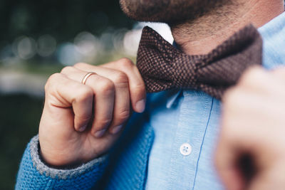 Close-up of man hand on bow