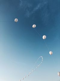 Low angle view of balloons against sky