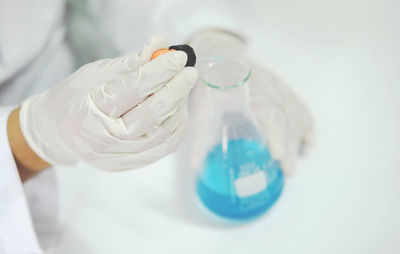 Close-up of scientist performing experiment at laboratory