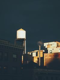 Low angle view of water tower against sky in city