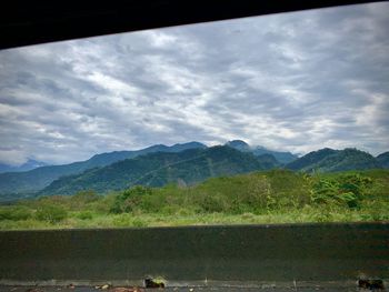 Scenic view of landscape and mountains against sky