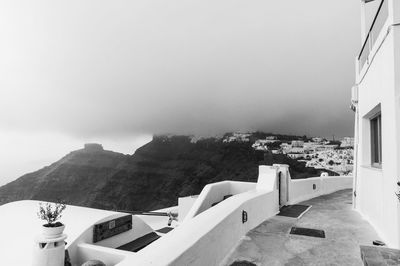 High angle view of mountains and townscape against cloudy sky