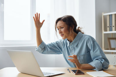 Young woman using laptop at office