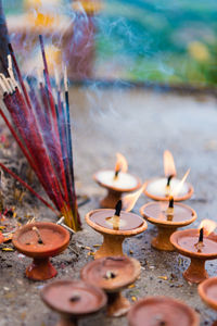 Close-up of lit oil lamps