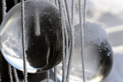 Close-up of glass marbles with strings during winter