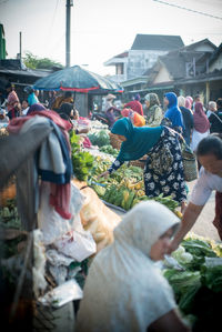 People at market stall in city