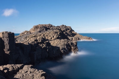 Scenic view of sea against clear blue sky