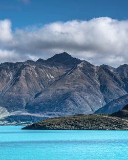 Scenic view of mountains against cloudy sky
