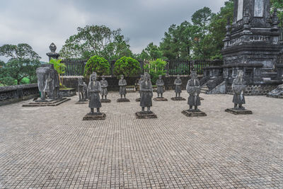 Statues at temple against sky