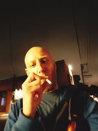 Man holding smoking at night