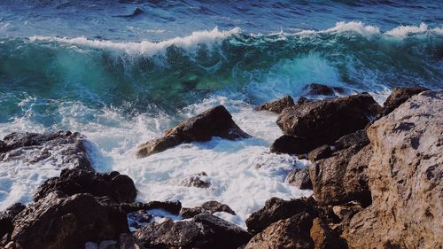 Waves splashing on rocks at shore