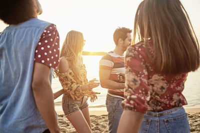 Rear view of people walking outdoors