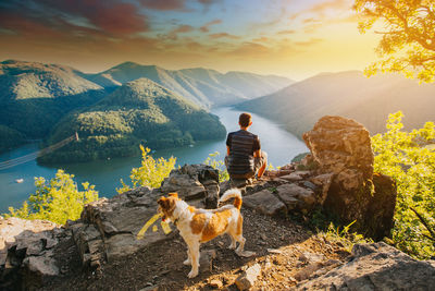 Rear view of woman with dog on mountain
