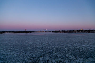 Scenic view of frozen lake against clear sky during winter