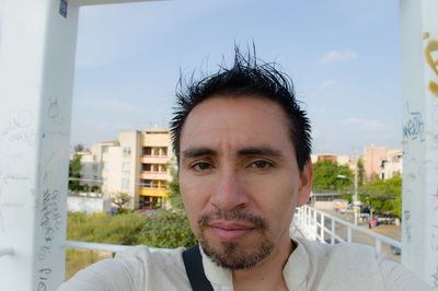 Portrait of young man looking at city