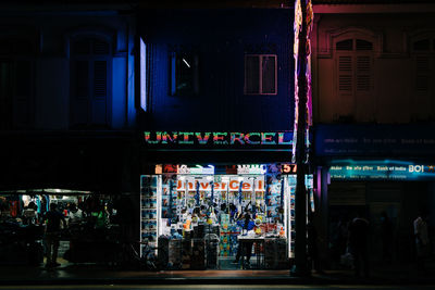 People at market in city at night