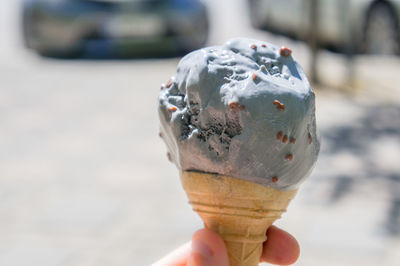 Close-up of hand holding ice cream cone