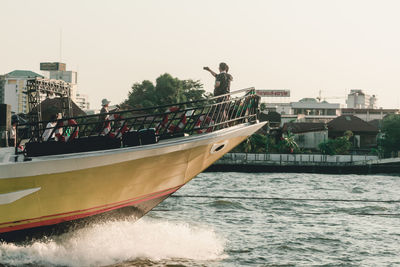 Panoramic shot of boats in sea against clear sky