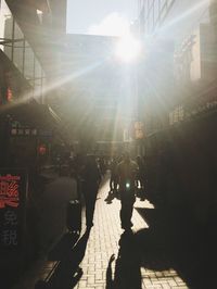 People walking on illuminated street in city