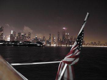 American flag against illuminated skyline