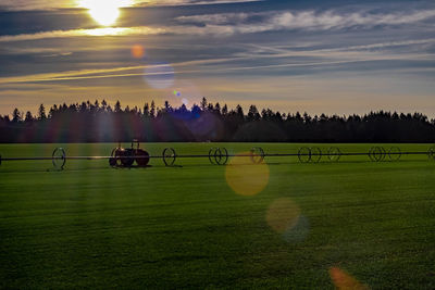 Scenic view of field against sky during sunset