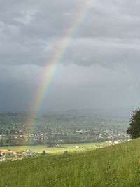 Scenic view of rainbow over field