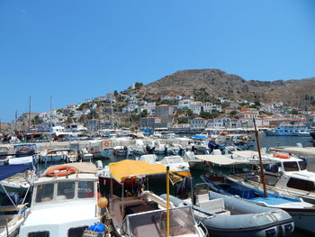 Boats moored on mountain against clear blue sky