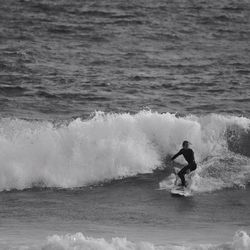 People surfing in sea