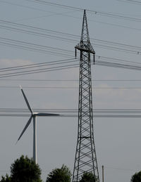 Low angle view of electricity pylon against sky