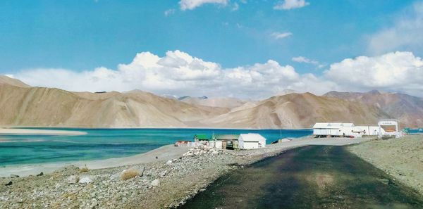 Scenic view of sea and mountains against sky