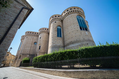 Low angle view of historical building against clear blue sky