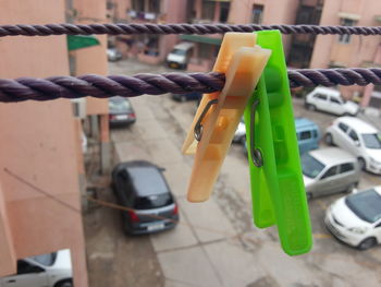 Close-up of clothespins attached to rope