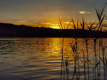 Scenic view of lake against romantic sky at sunset