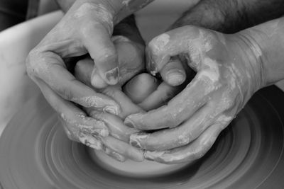 Cropped image of hands making pot