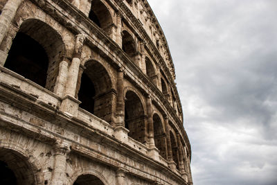 Low angle view of historical building against cloudy sky