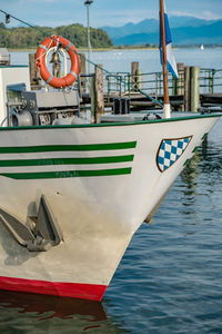 Boat moored at harbor against sky