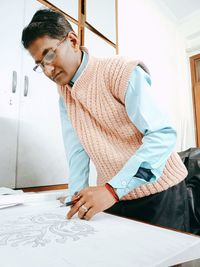 Full length of young man standing on table