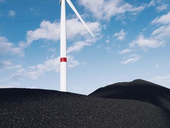 Low angle view of wind turbine against sky