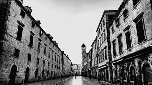 Street amidst buildings against sky in city