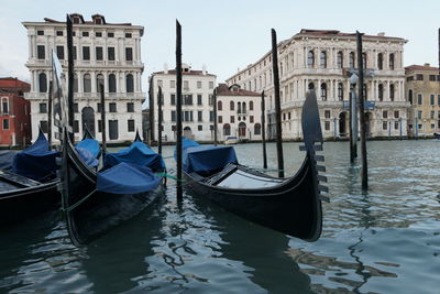 Boats in river with buildings in background