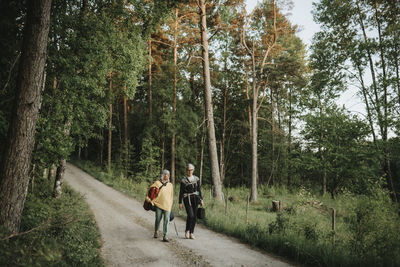 Two senior women hiking in forest