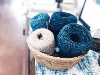 High angle view of thread spools in basket