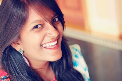 Close-up portrait of smiling young woman