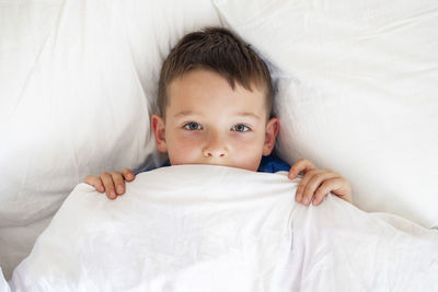 Portrait of cute baby boy sleeping on bed at home