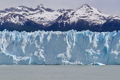 Scenic view of snowcapped mountains and glacier against sky