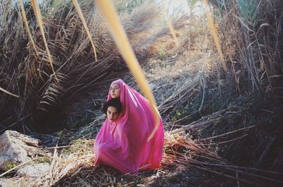 Portrait of woman standing in forest