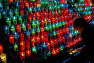 Full length of man holding illuminated candles