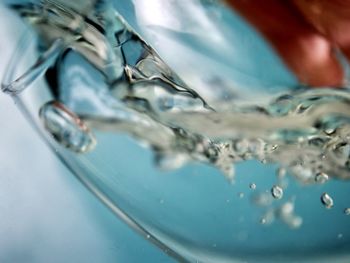 Close-up of water dropping into glass