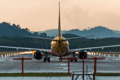 Airplane on runway against sky